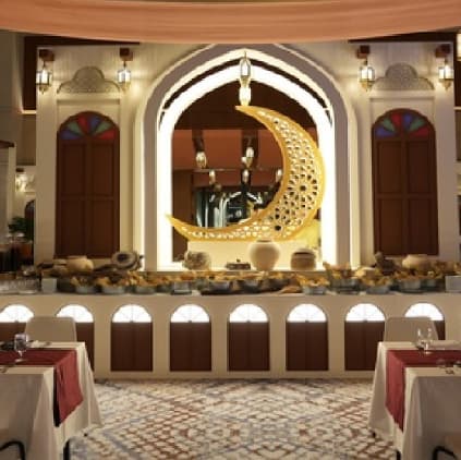 A Ramadan tent dining hall beneath a golden crescent at Sheraton Bahrain Hotel
